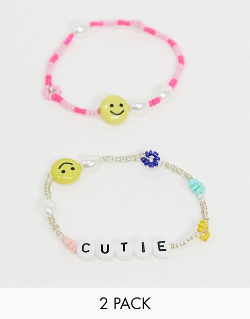 ASOS DESIGN pack of two beaded bracelets with flower pearl and happy face charms