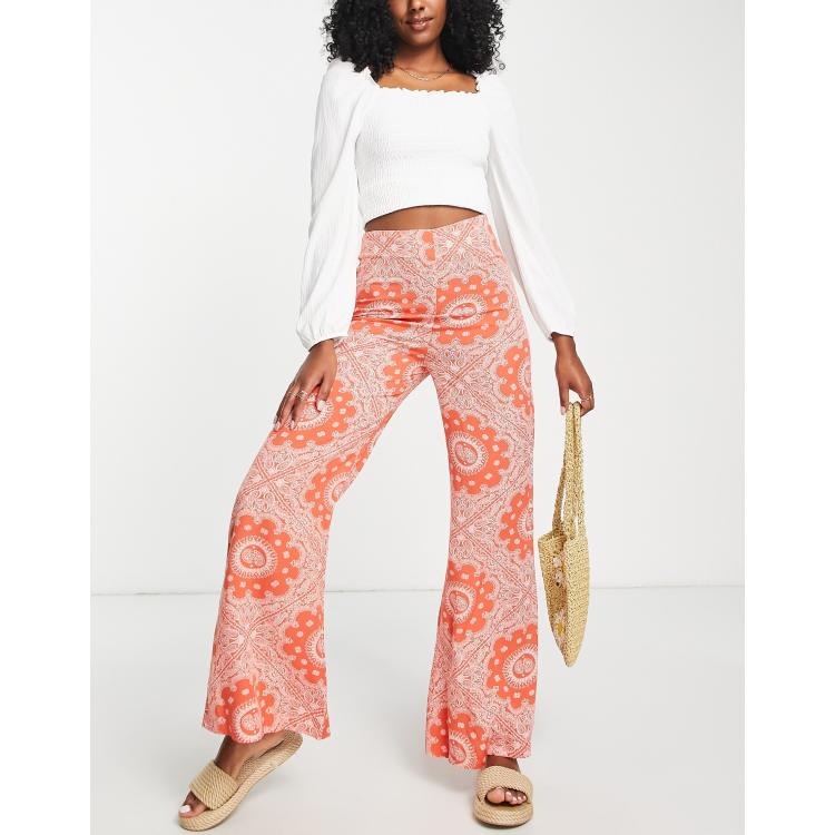 ASOS DESIGN retro floral flare pants in orange