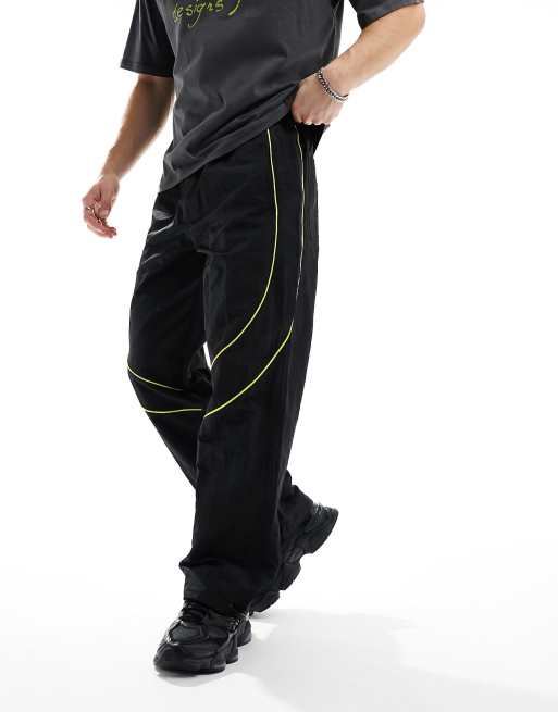 ASOS DESIGN paneled piping track pants in black and yellow sheen nylon, 4 of 5