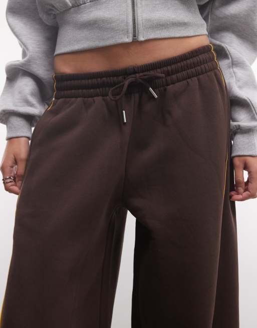 ASOS DESIGN panelled extreme wide leg jogger with piping details in brown and yellow, 3 of 5