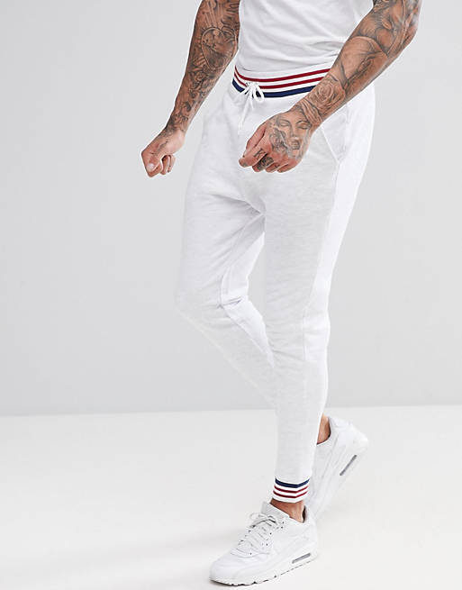 ASOS DESIGN - Pantalon de jogging fuselé avec liseré - Blanc chiné
