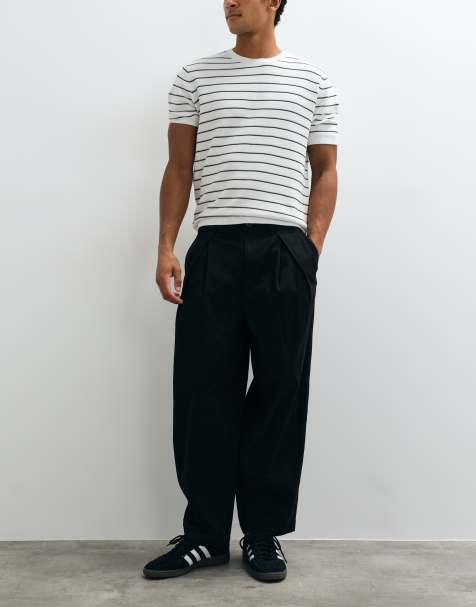 ASOS DESIGN - Pantalón tapered extragrande en negro con pliegues invertidos - view 1