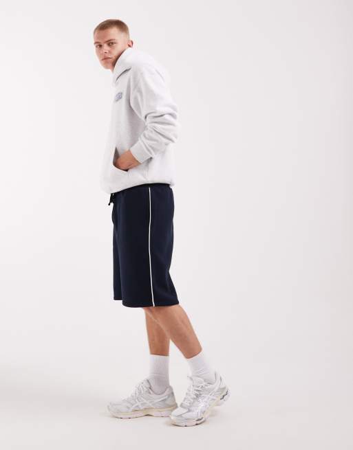 ASOS DESIGN - Pantaloncini bermuda oversize taglio lungo in jersey blu navy con profili a contrasto