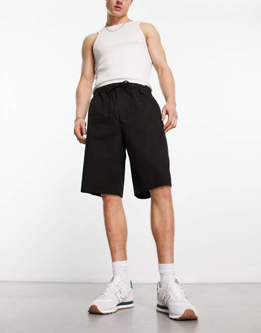 ASOS DESIGN - Pantaloncini chino stile skater neri taglio lungo