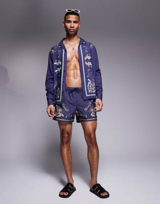 ASOS DESIGN - Pantaloncini da bagno taglio corto blu navy con motivo sui bordi in coordinato