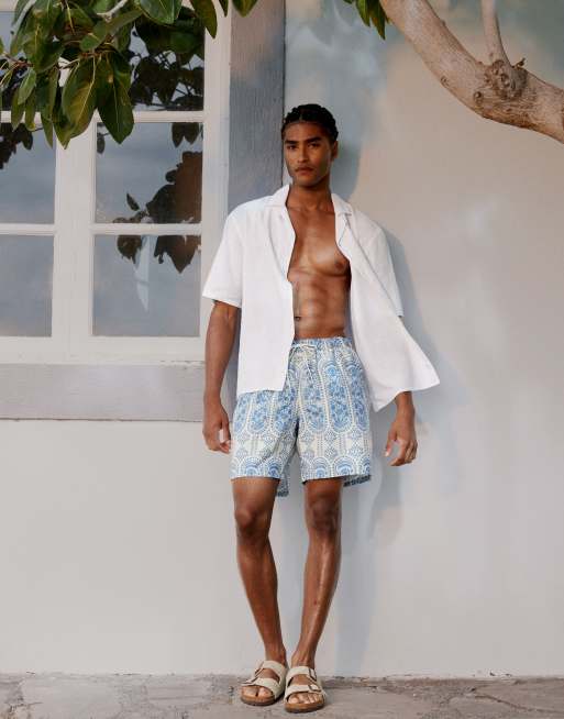 ASOS DESIGN - Pantaloncini da bagno taglio medio blu con stampa a fiori