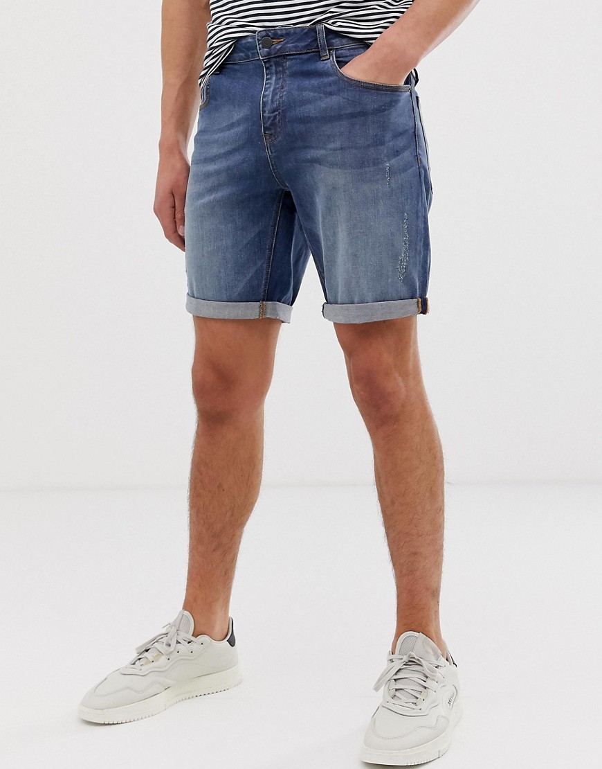 ASOS DESIGN - Pantaloncini di jeans slim lavaggio medio con abrasioni-Blu
