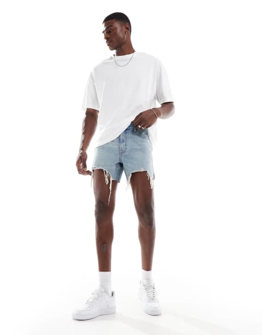 ASOS DESIGN - Pantaloncini di jeans slim taglio corto blu lavaggio chiaro con strappi