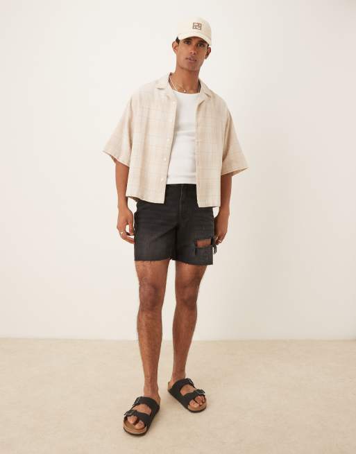 ASOS DESIGN - Pantaloncini di jeans slim taglio medio neri con strappi