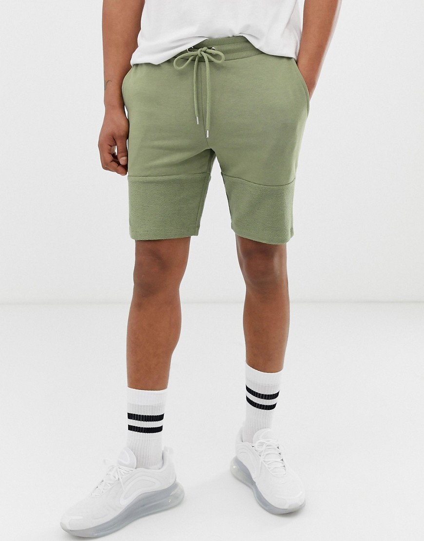 ASOS DESIGN - Pantaloncini skinny in jersey verde con pannello effetto rovescio