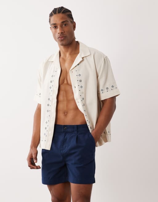 ASOS DESIGN - Pantaloncini taglio corto blu navy con pieghe