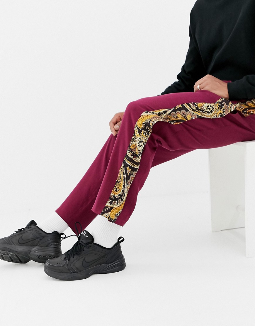 ASOS DESIGN - Pantaloni comodi con bottoni a pressione e dettagli laterali con stampa cachemire-Rosso