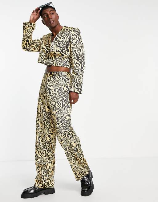 ASOS DESIGN - Pantaloni da abito a fondo ampio neri e arancioni con stampa astratta