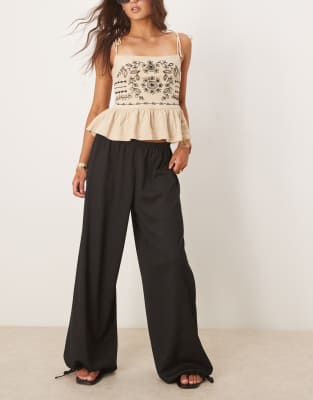 ASOS DESIGN - Pantaloni neri testurizzati a palloncino con fondo elasticizzato