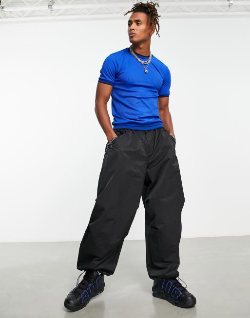 Weekday Unisex parachute baggy pants in orange exclusive to ASOS