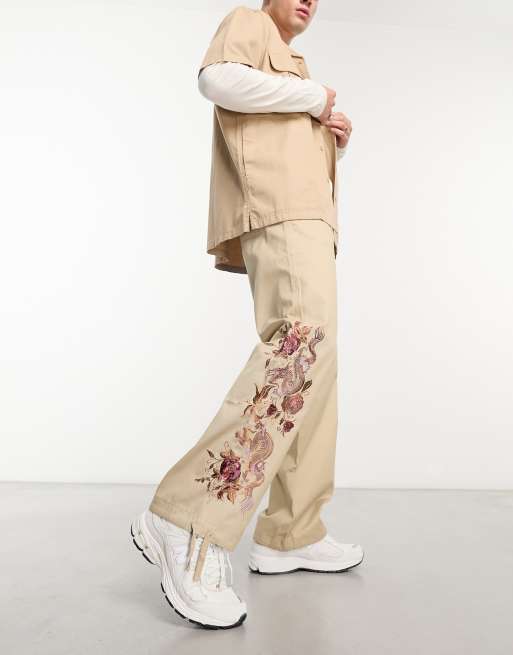 ASOS DESIGN parachute trouser with dragon embroidery in washed stone