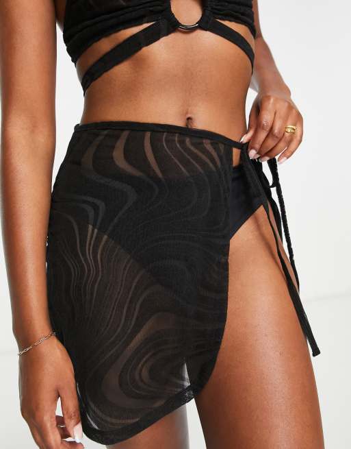 ASOS DESIGN - Pareo da spiaggia corto in rete floccato nero in coordinato