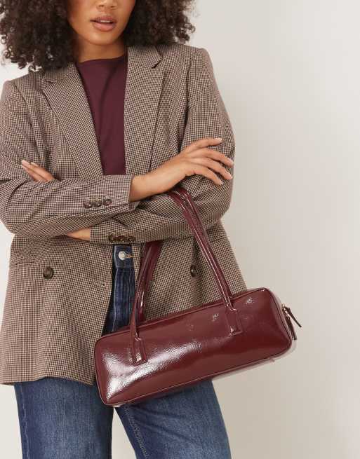 ASOS DESIGN patent elongated bowler bag in burgundy