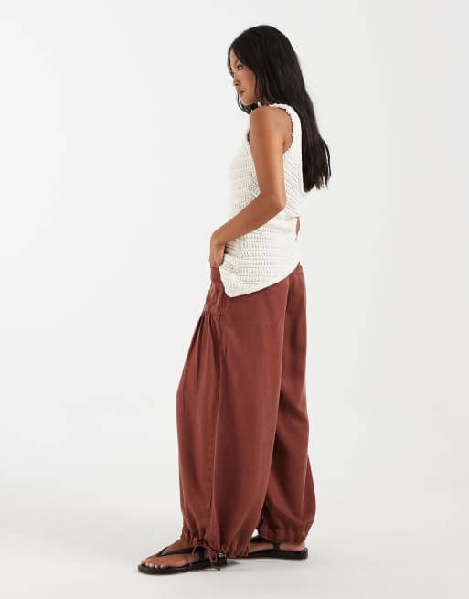 ASOS DESIGN Petite balloon trouser with front pockets and adjustable tie hem in rust, 3 of 5