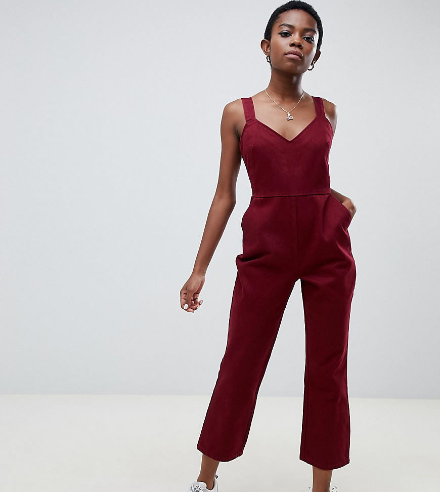 ASOS DESIGN Petite denim jumpsuit with kickflare in berry-Red