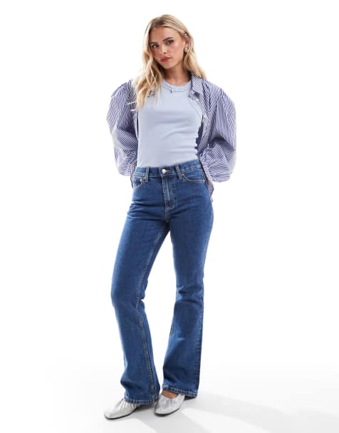 ASOS DESIGN Petite mid rise flare jeans in mid blue