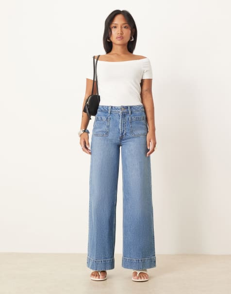 ASOS DESIGN Petite high waist wide leg jeans with front pockets in&nbsp;mid blue