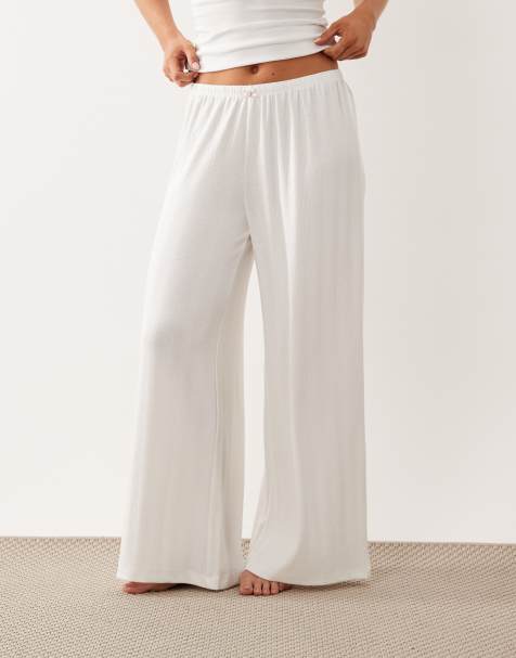 ASOS DESIGN Petite pointelle wide leg pyjama trousers with rosebud trim in white - view 1