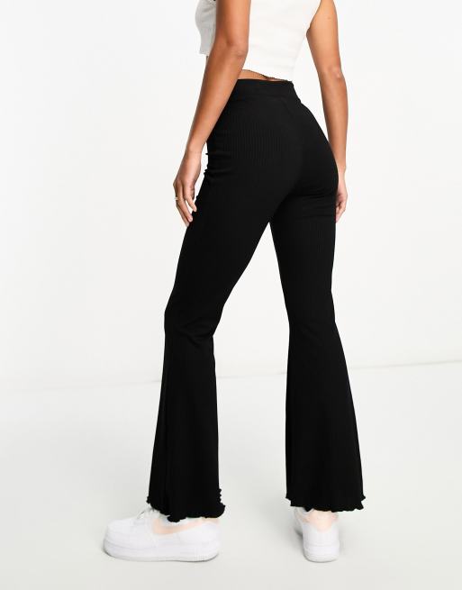 ASOS DESIGN Petite rib flare pants with lettuce hem in black | ASOS