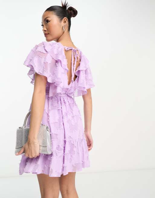 ASOS DESIGN Petite v front ruffle mini dress with flutter sleeves and tie belt in textured jacquard in lilac