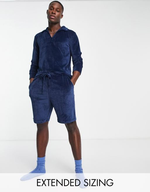 ASOS DESIGN - Pigiama in velour blu navy a coste con polo a maniche lunghe e pantaloncini