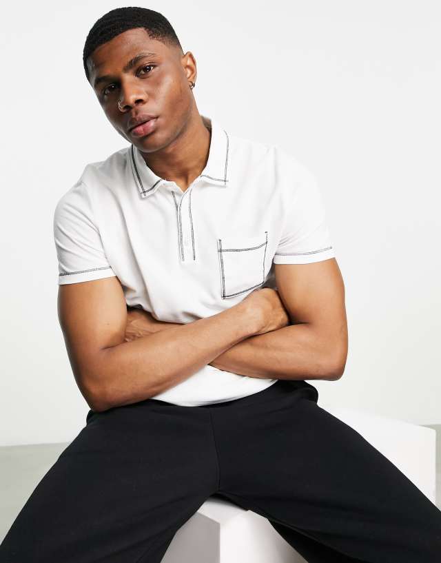 ASOS DESIGN pique polo in white with black stitching and pocket detail