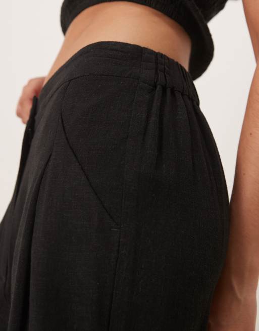 ASOS DESIGN pleat front tapered pants with linen in black