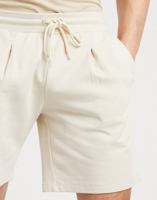 ASOS DESIGN pleated jersey shorts in beige