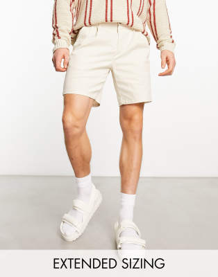 ASOS DESIGN pleated shorts in mid length in beige