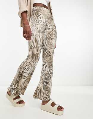 Shop Asos Design Plisse Flare Pants In Mixed Animal Print-multi