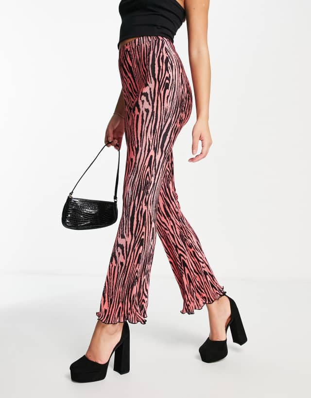 ASOS DESIGN plisse flare pants in pink and black animal print