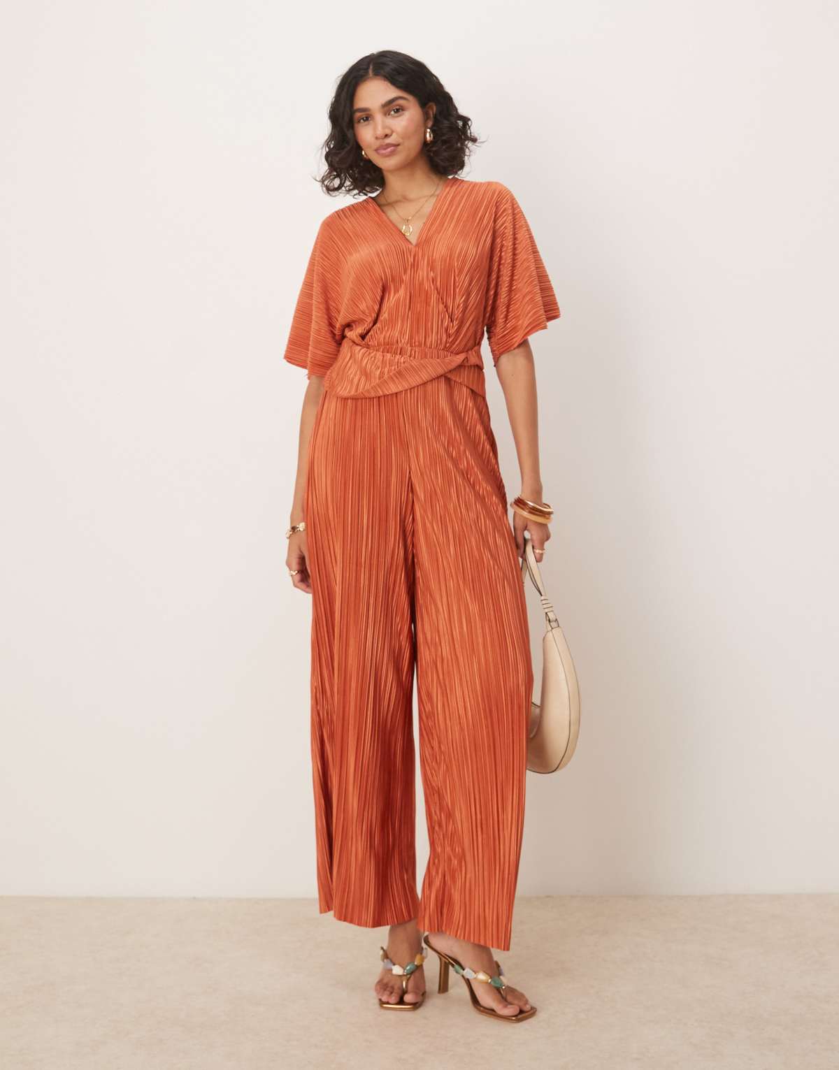ASOS DESIGN plisse plunge short sleeve wrap waist jumpsuit in rust