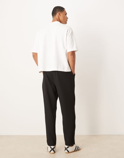 ASOS DESIGN plisse tapered pants in black
