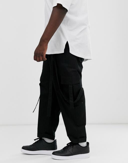 ASOS DESIGN Plus cargo pants in black with strapping