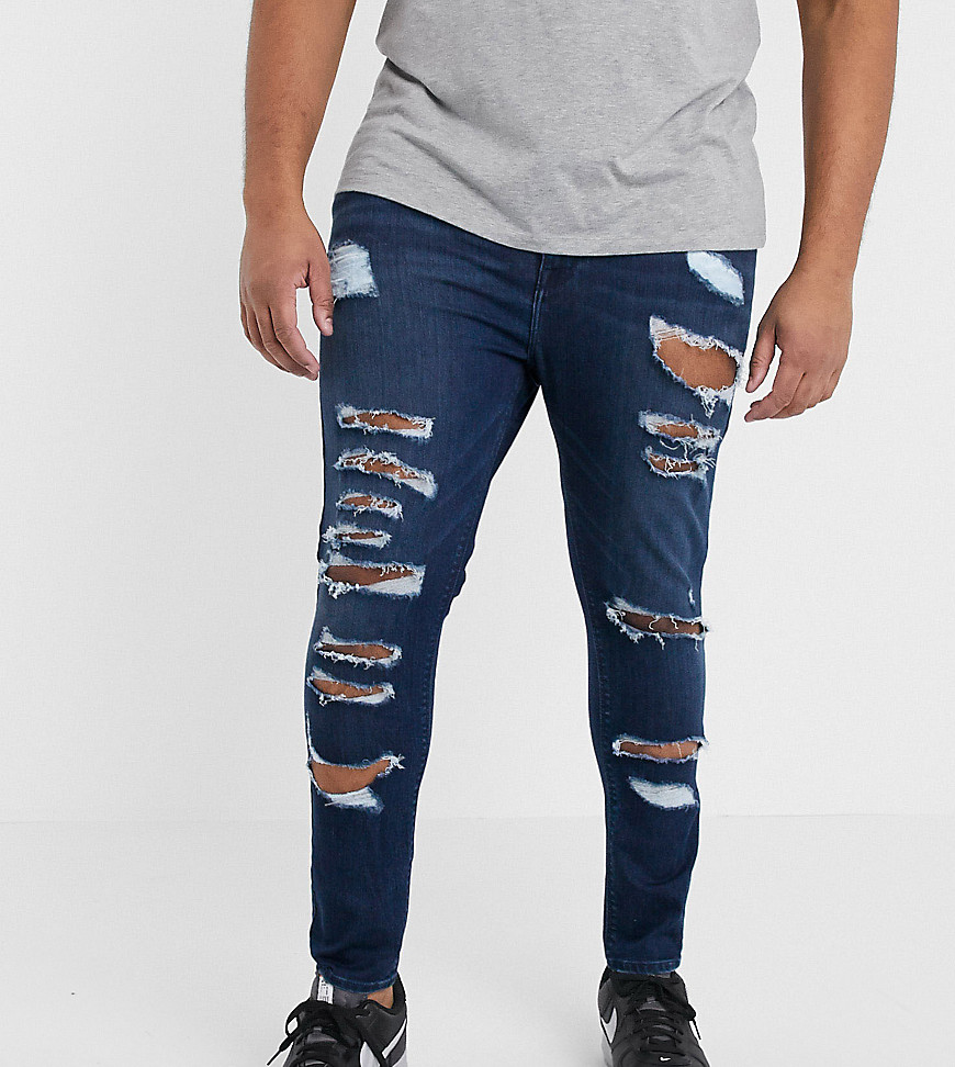 ASOS DESIGN Plus - Jeans super stretch effetto spray lavaggio blu scuro con strappi vistosi