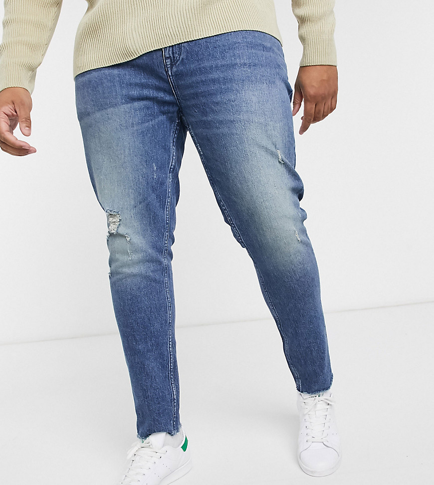 ASOS DESIGN - Plus - Skinny 'American classic' jeans in blauwe midwash met slijtplekken en onafgewerkte zoom