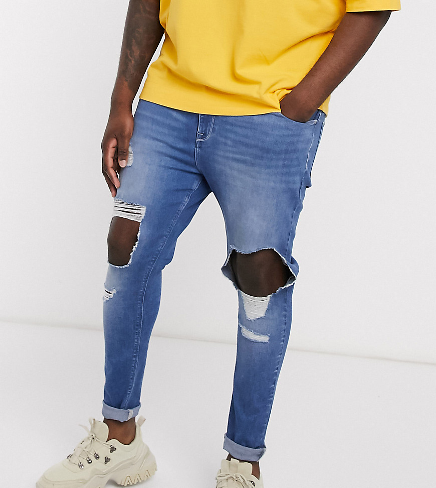 ASOS DESIGN Plus spray on jeans in power stretch with open rips in mid blue