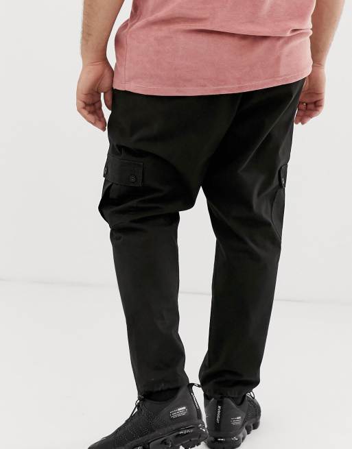 ASOS DESIGN tapered cargo pants in black with toggles