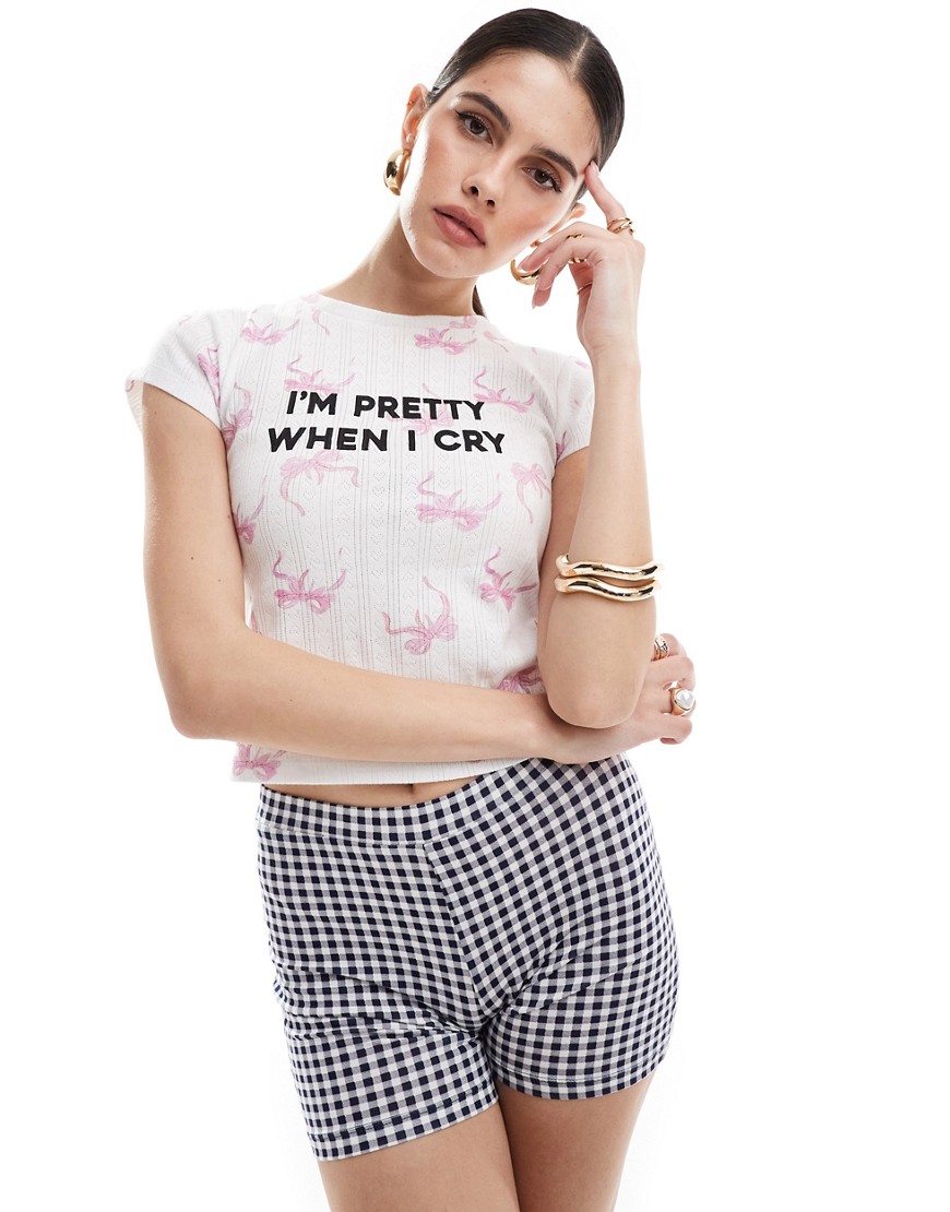 ASOS DESIGN pointelle baby tee with pretty slogan graphic in all over bow print-Multi