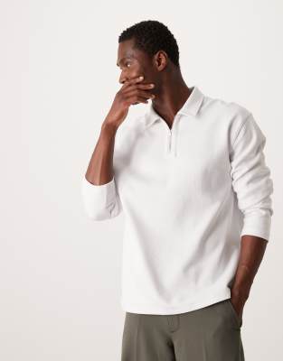 ASOS DESIGN - Polo décontracté en maille interlock de qualité supérieure à manches longues et col zippé - Blanc