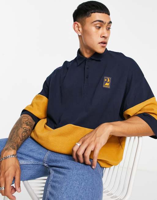 ASOS DESIGN - Polo oversize in piqué color block blu navy e mostarda