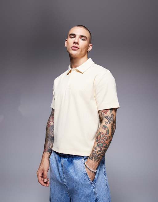 ASOS DESIGN - Polo taglio corto giallo pallido a coste con ricamo sul petto