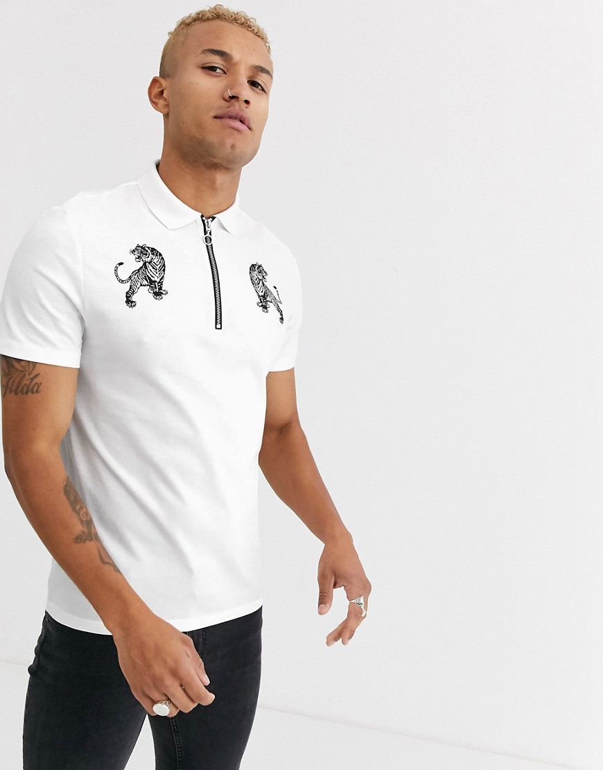 ASOS DESIGN polo with tiger print and zip neck collar-White