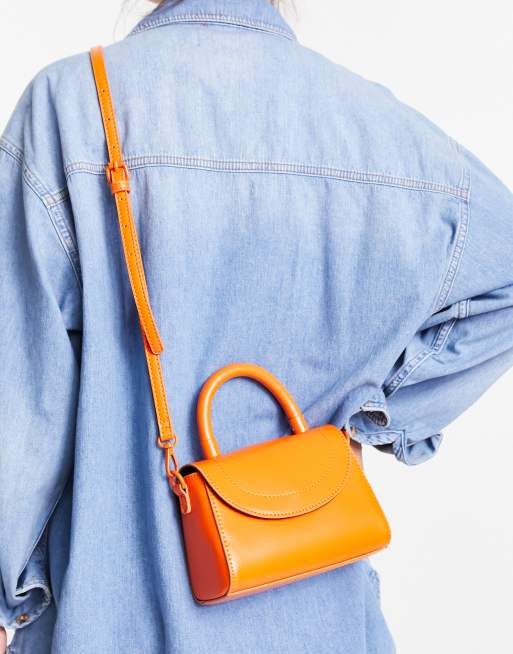 ASOS DESIGN – Pomarańczowa kopertowa torebka crossbody z zaokrągloną klapką, uchwytem na górze i odpinanym paskiem