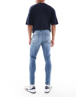 ASOS DESIGN power stretch jeans in mid wash blue